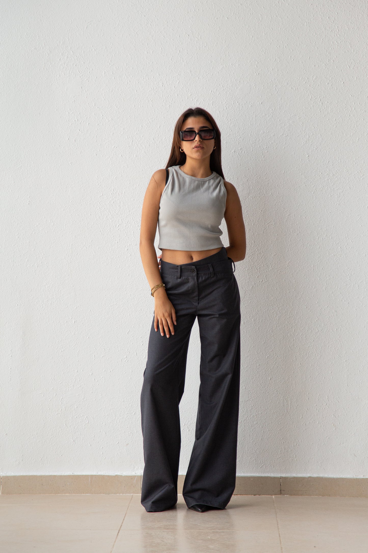 Pants with asymmetric waist detail