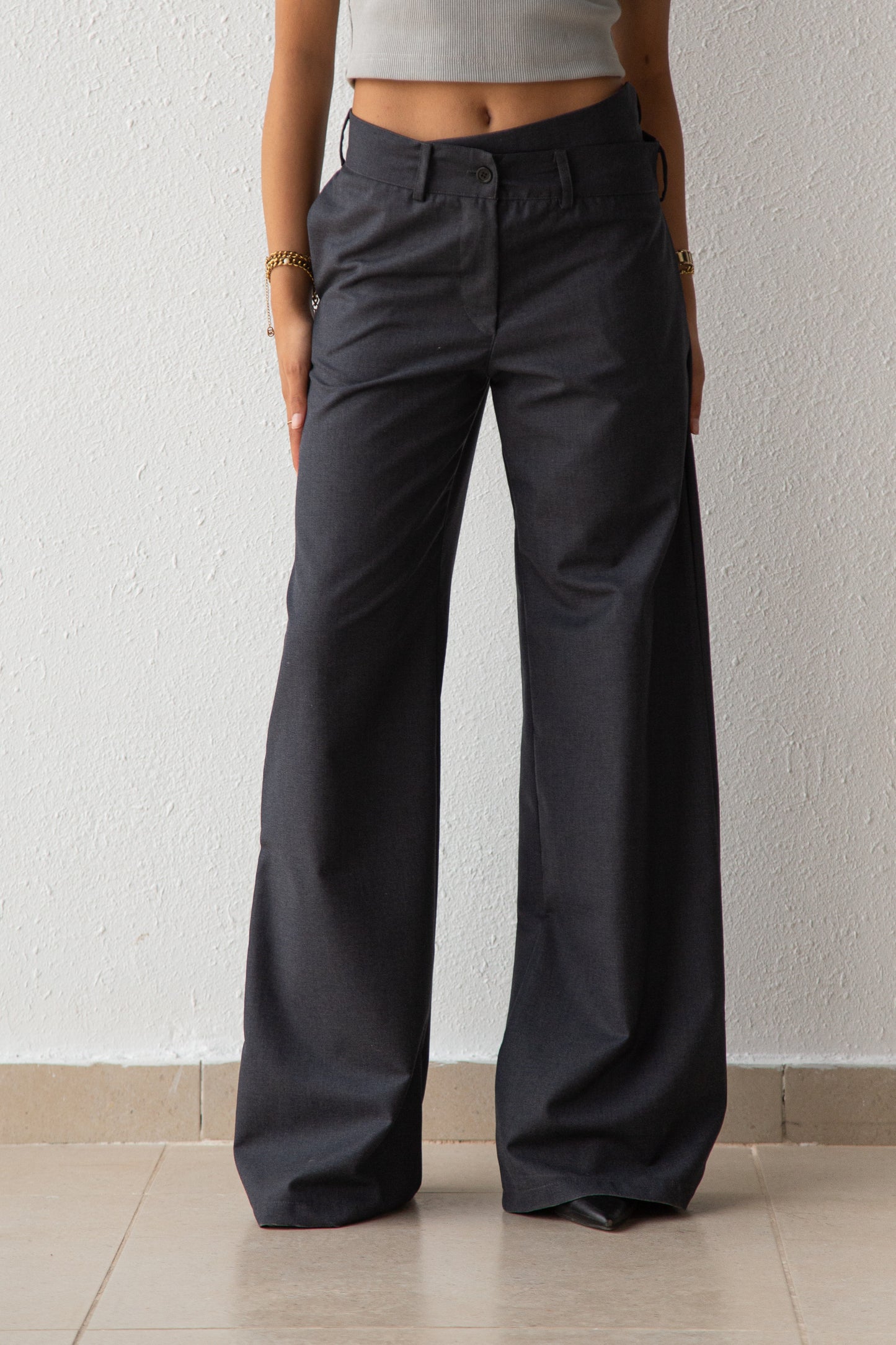 Pants with asymmetric waist detail