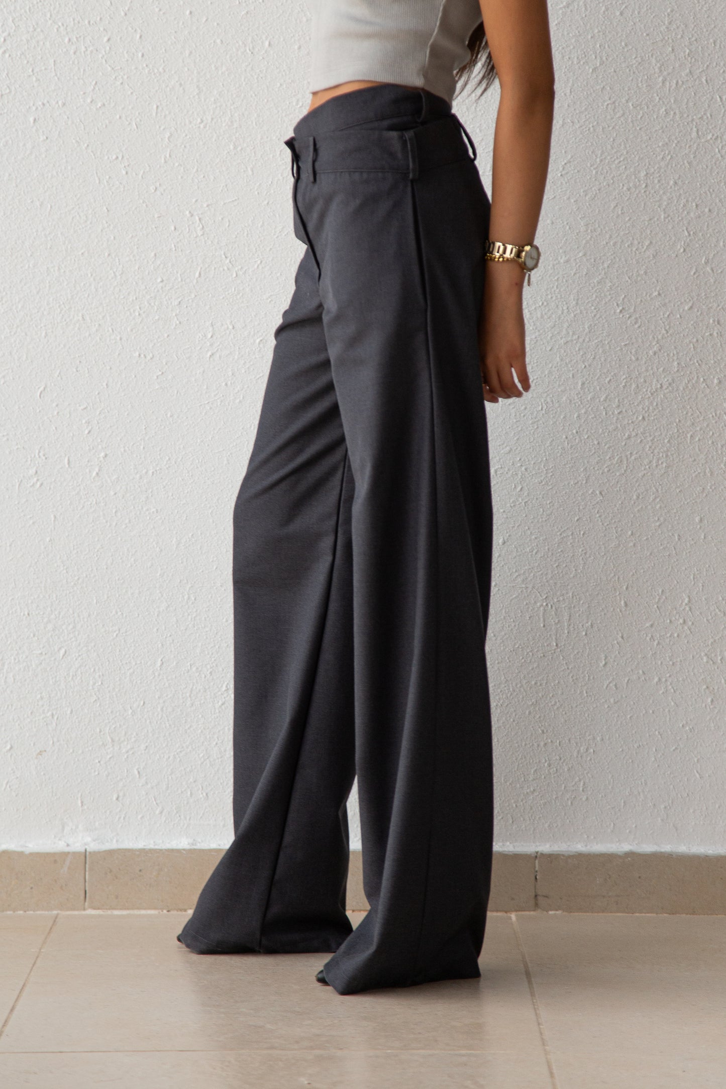 Pants with asymmetric waist detail